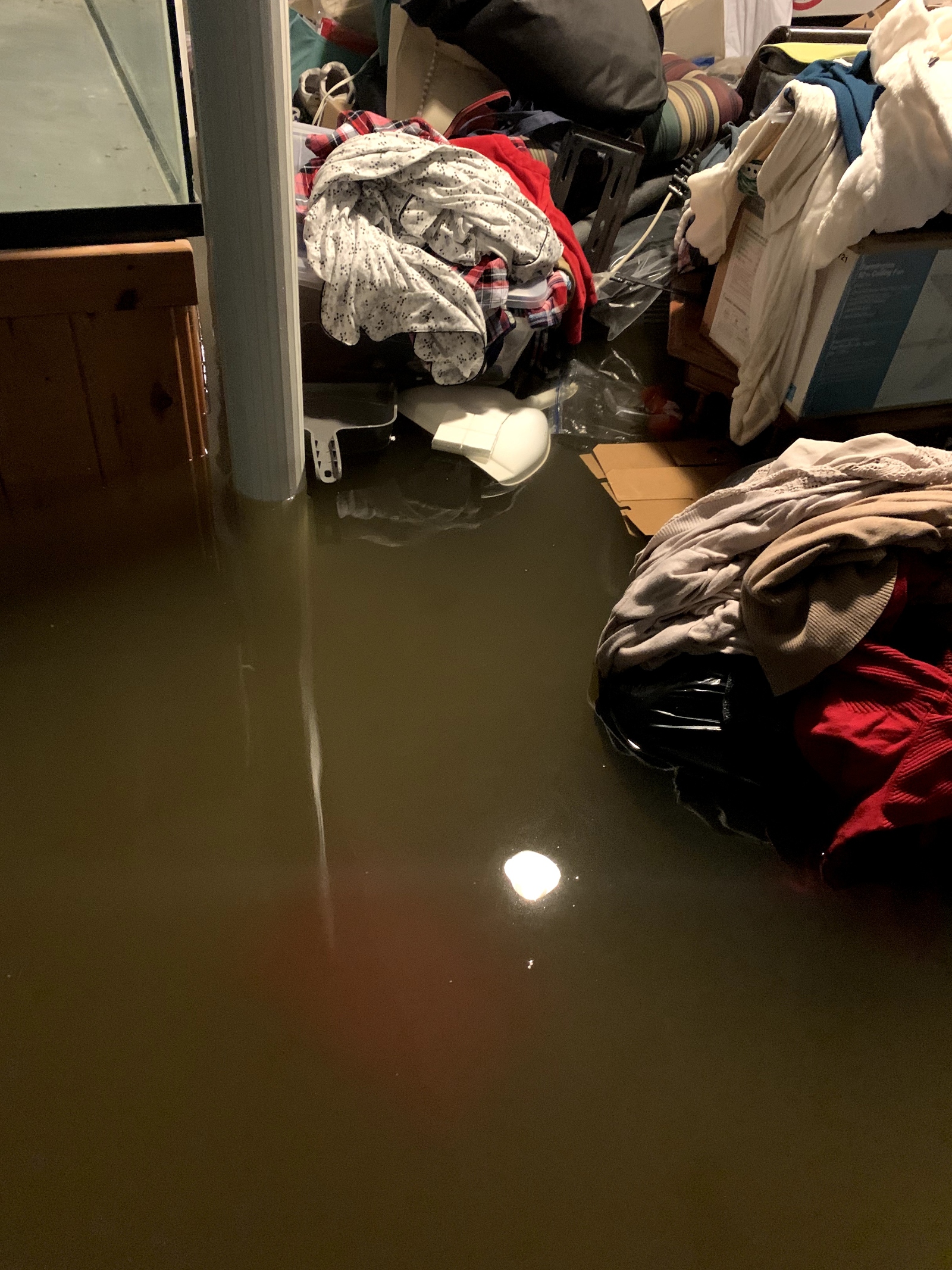 Clothes floating in a flooded basement