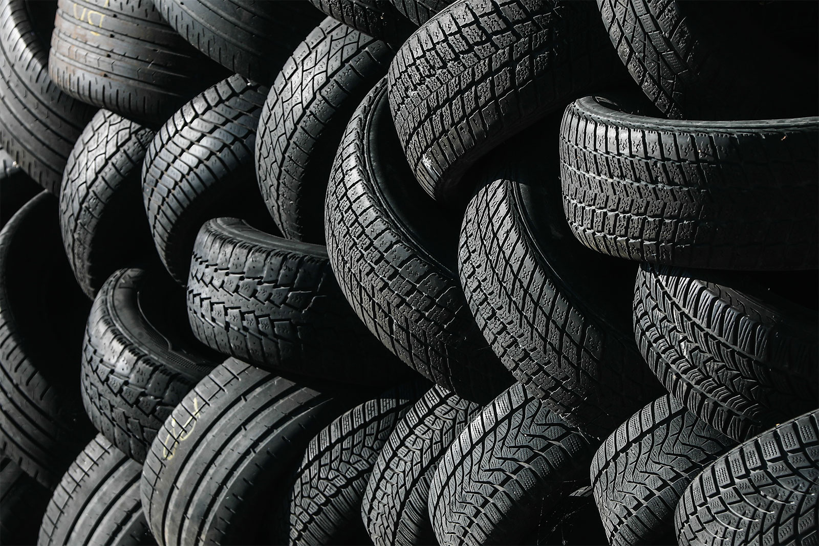 Close-up of a large stack of black car tires