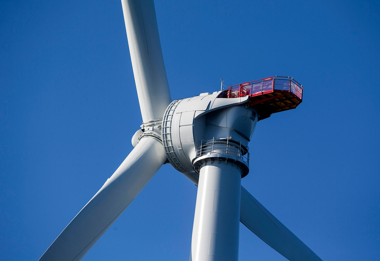Close-up of wind turbine against blue sky