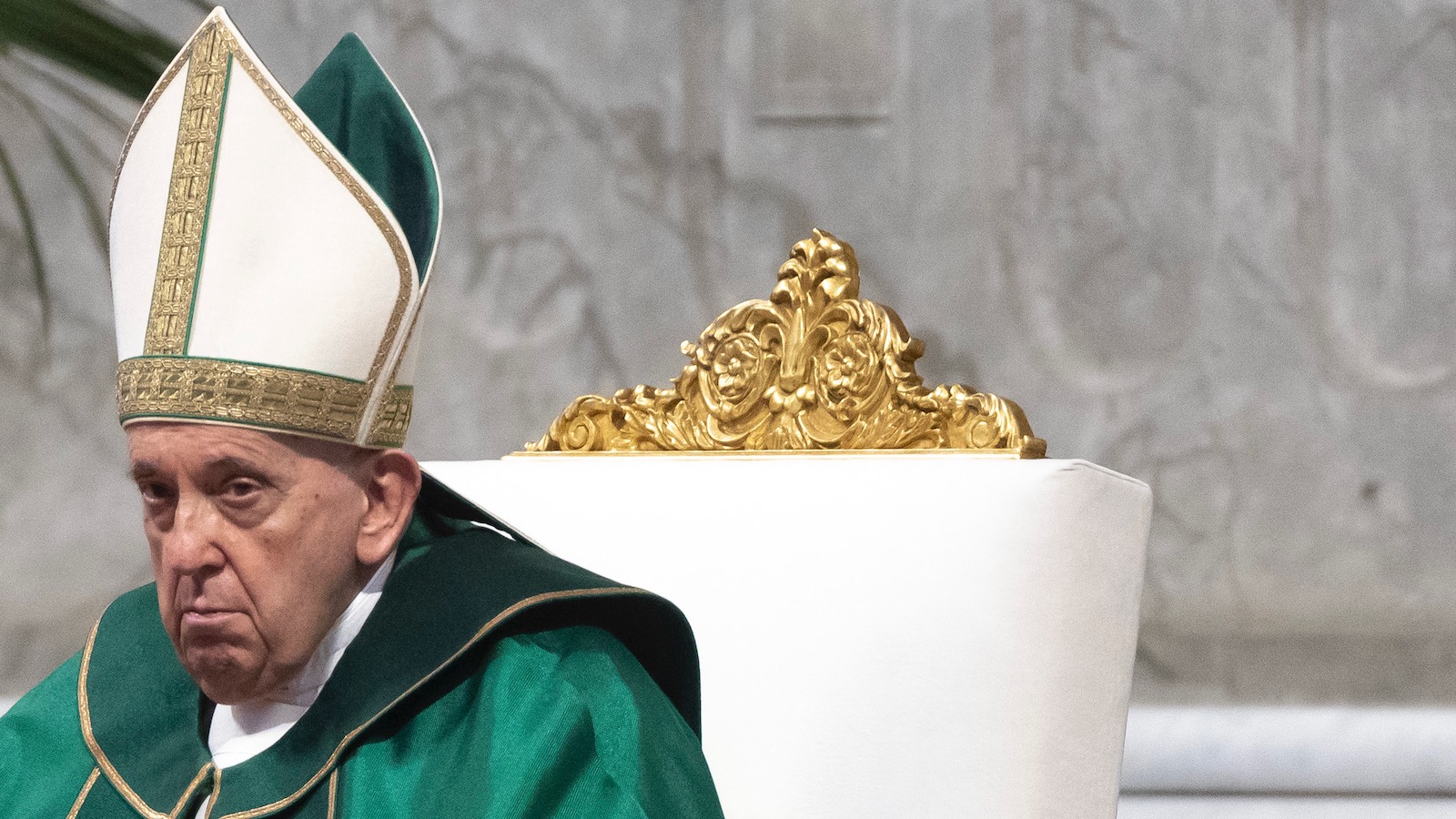 Pope Francis is seen wearing green vestments and seated in St. Peter's Basilica at the Vatican.
