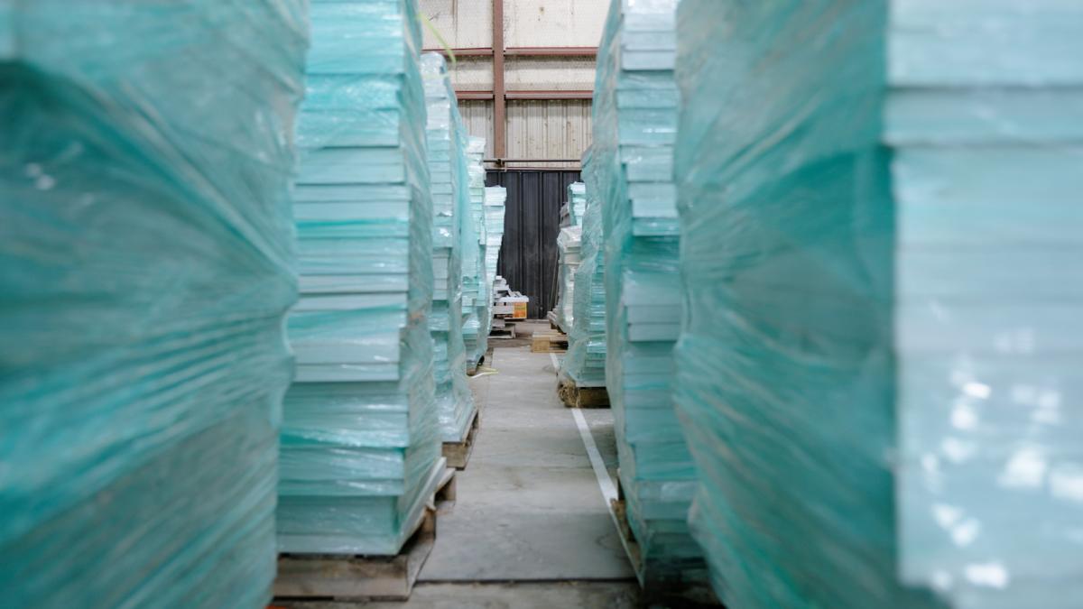Towers of glass panels wrapped in plastic.