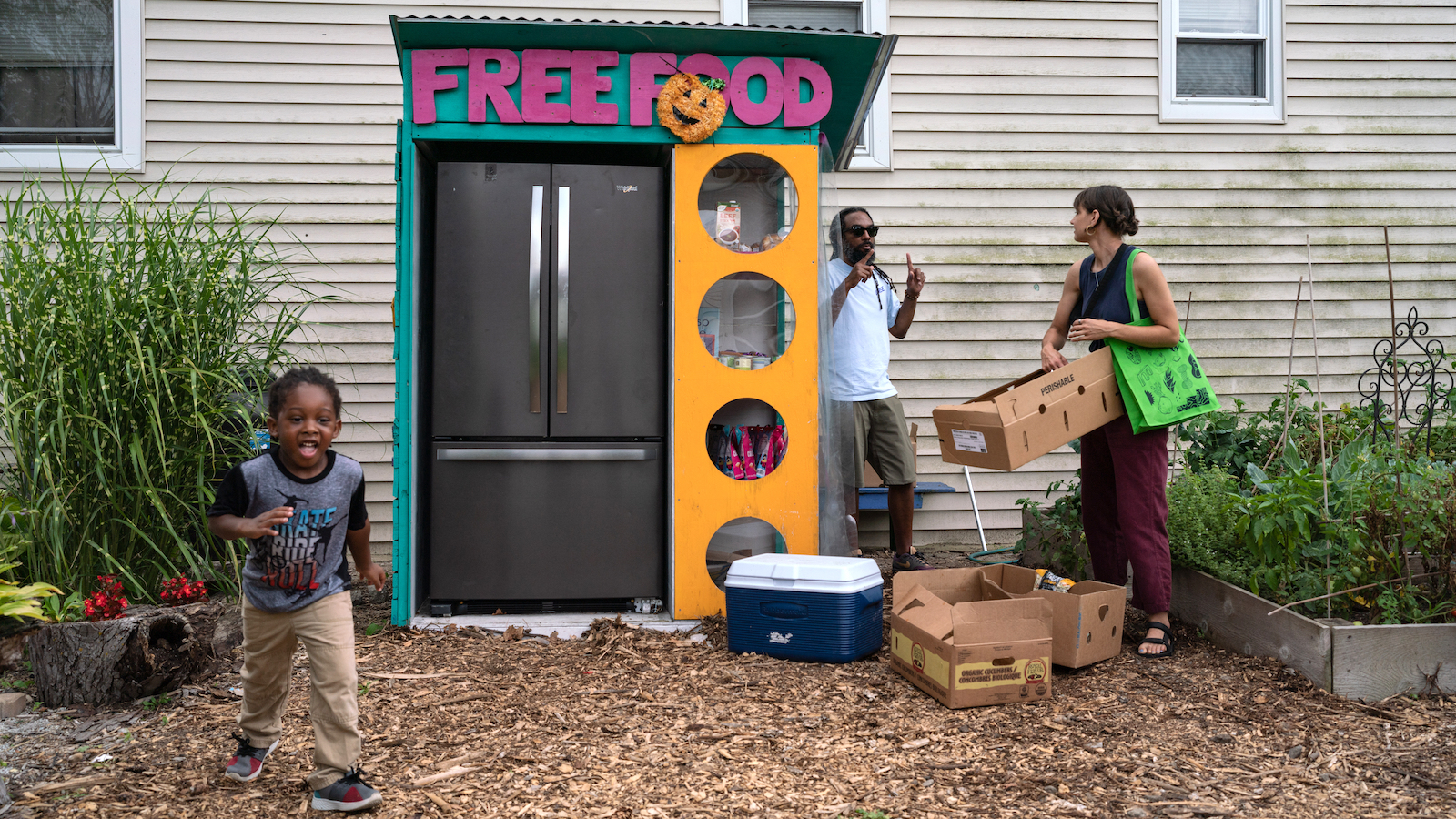 Volunteers help out at a community fridge run by the Love Fridge, a mutual aid group in Chicago