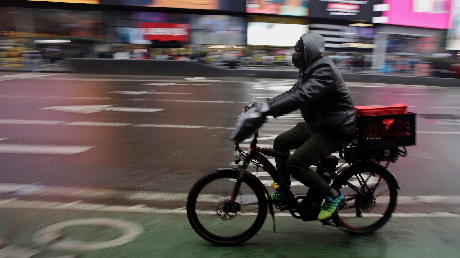 A man rides an e-bike through Times Square on February 21, 2023 in New York City.