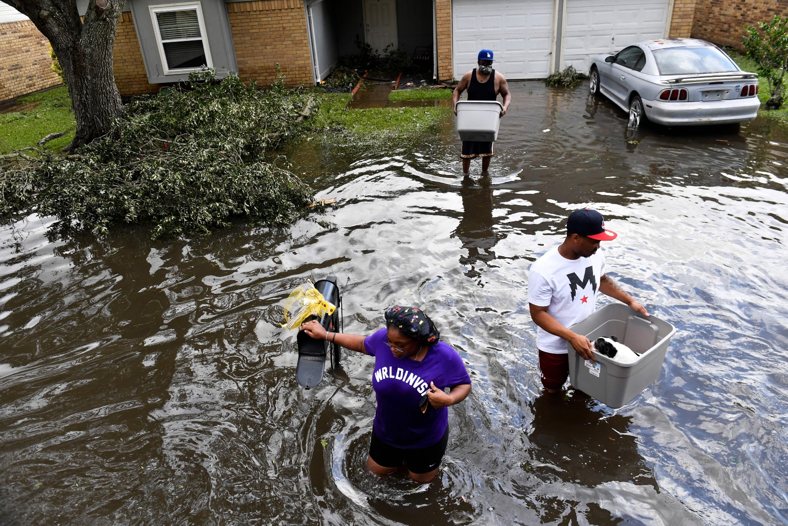 Residents in LaPlace, Louisiana, help evacuate neighbors from flooded homes on August 30, 2021, in the aftermath of Hurricane Ida.