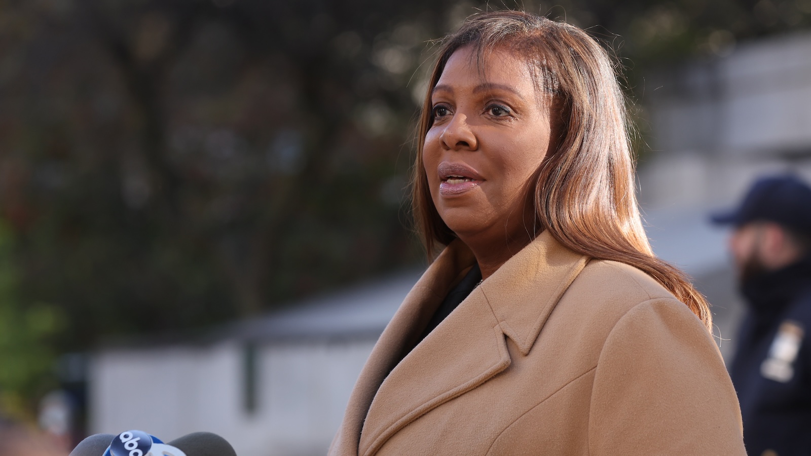 Letitia James speaks to a microphone