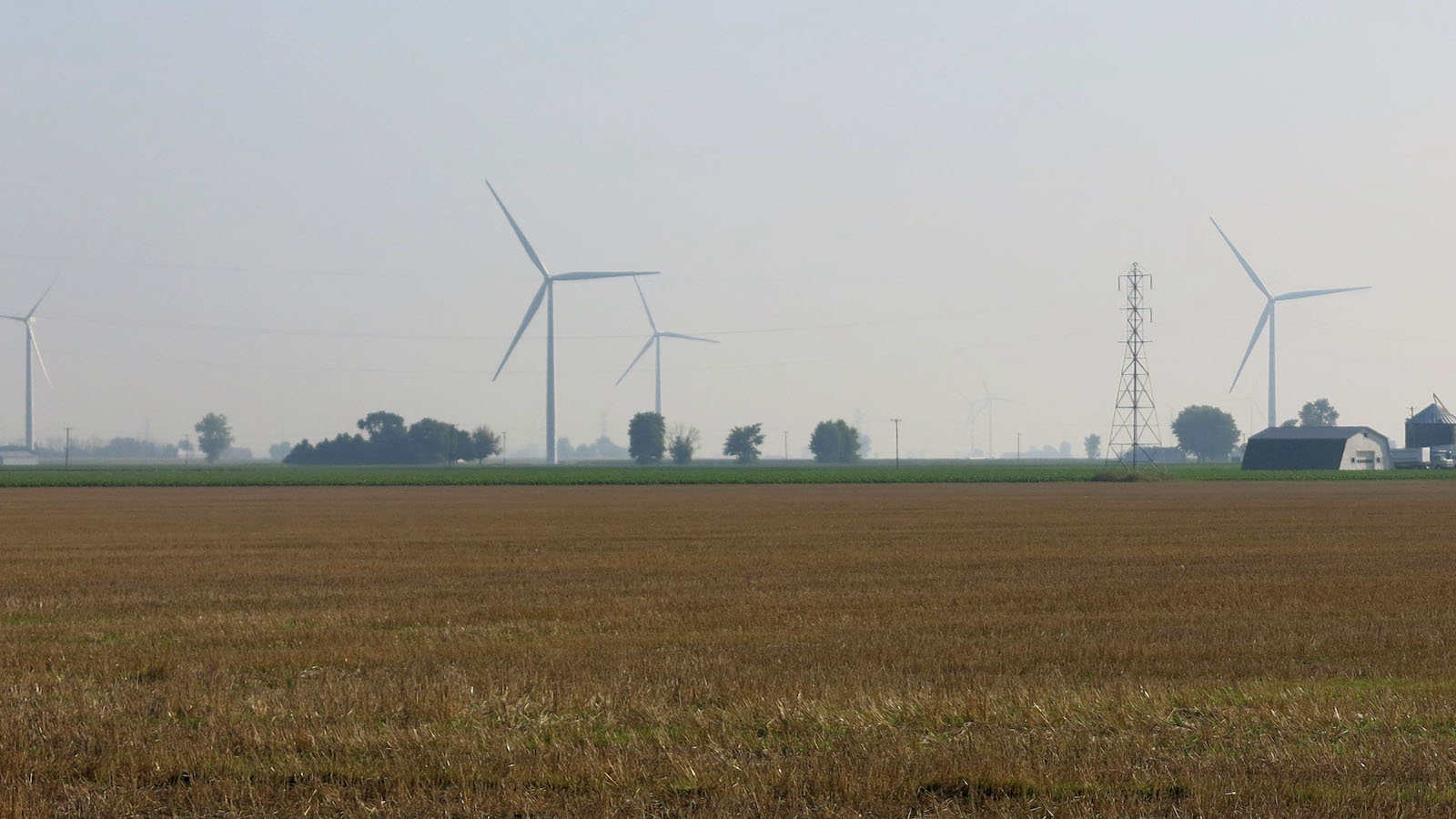 Wind turbines on a farm field.
