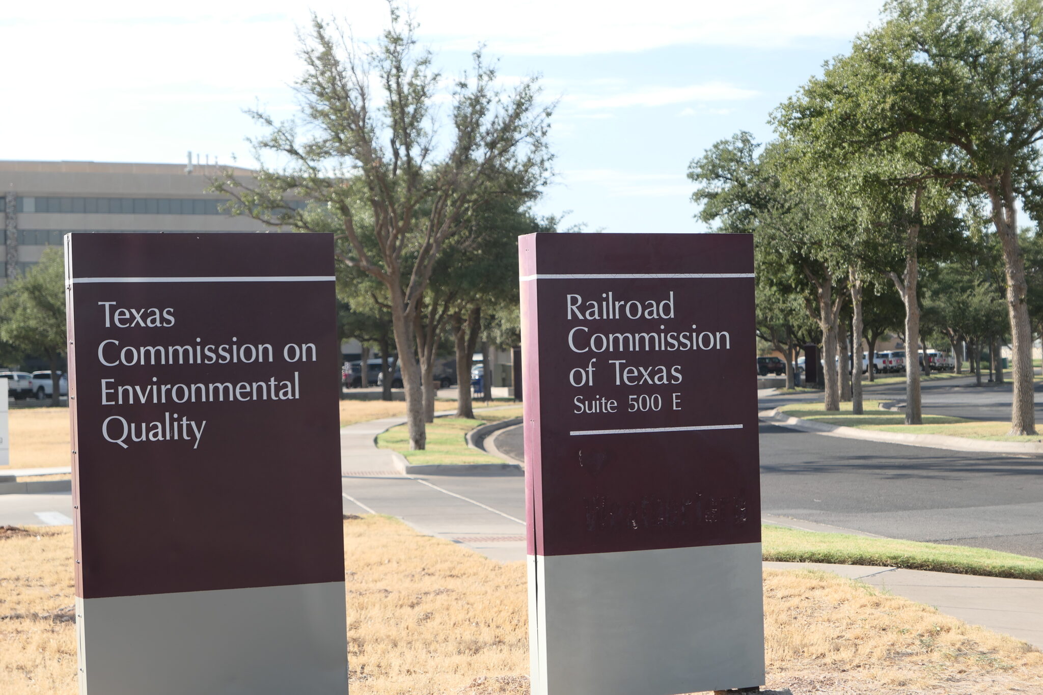 Two signs that read Railroad Commission of Texas and Texas Commission on Environmental Quality.