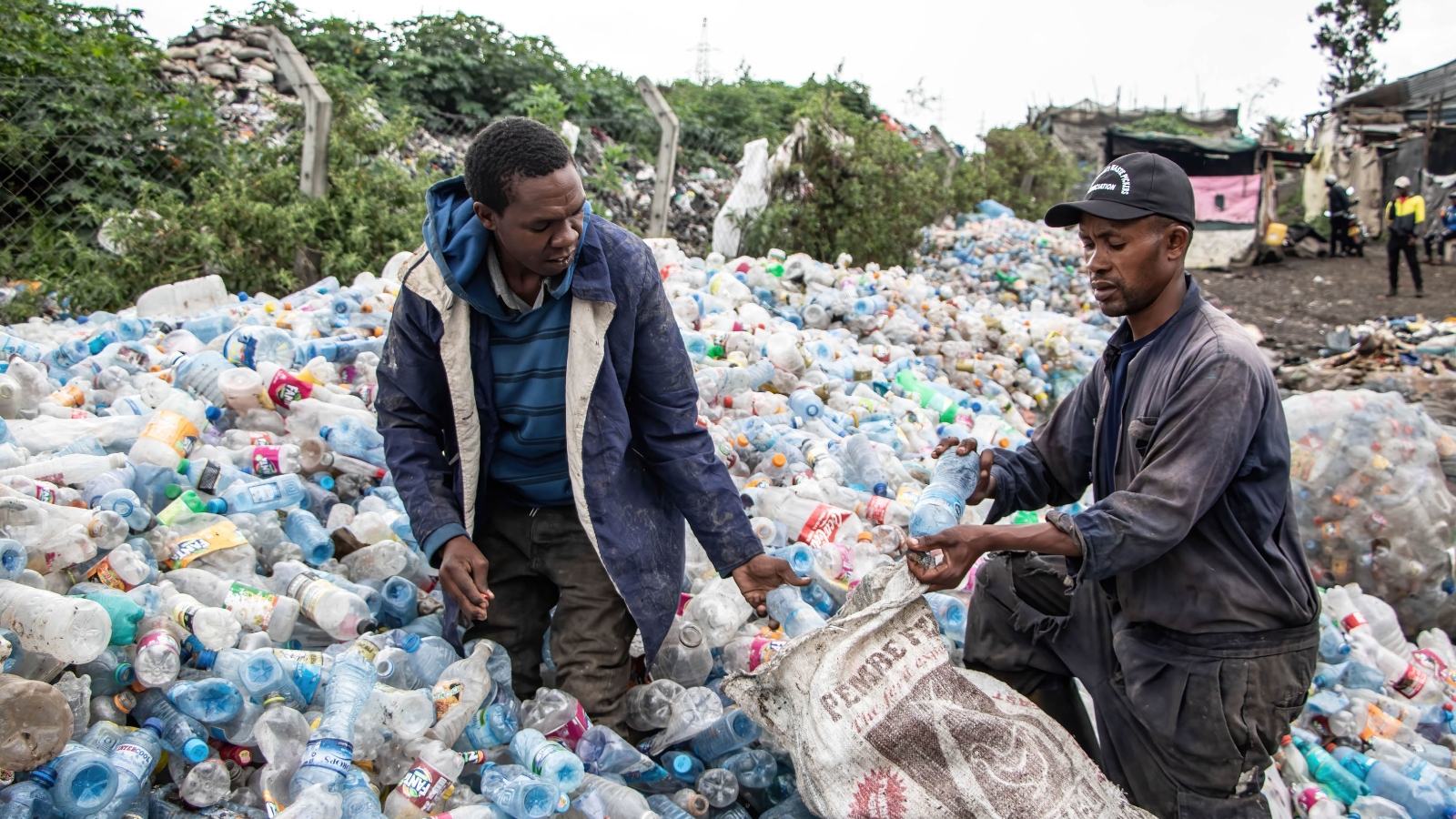Amos Mwangi and Paul Wanja, members of Nakuru County Waste Pickers Association, work at the Gioto dumping site in Nakuru, Kenya, on November 8, 2023.