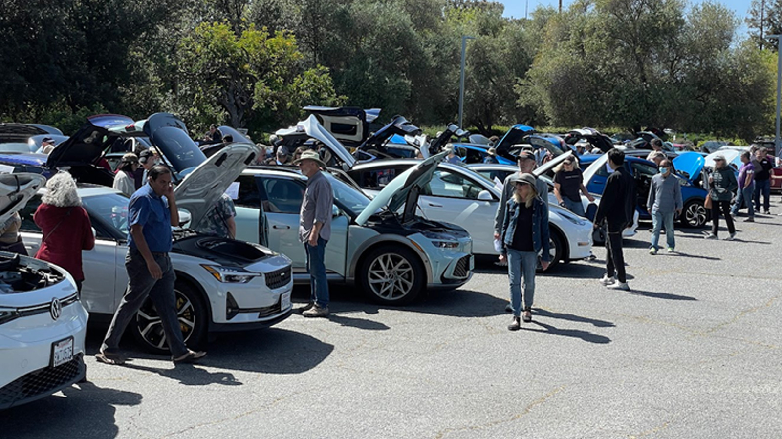 people look at cars at an EV expo