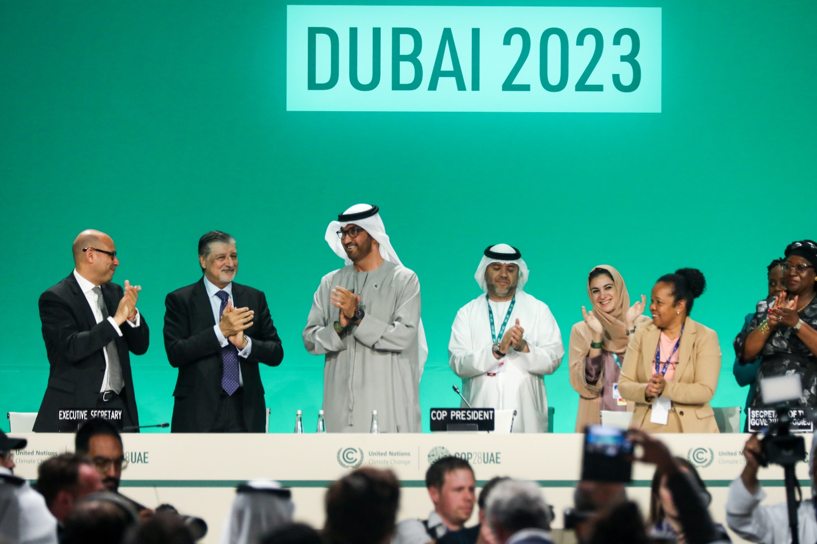 Delegates applaud after a speech by Sultan Ahmed Al Jaber, third from left, on the final day of COP28. Al Jaber, the head of the Emirati state oil company, drew criticism for seeming to dismiss the idea of a fossil fuel phaseout.