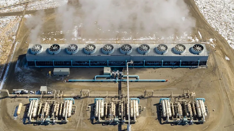 An aerial shot of an industrial facility belching steam.