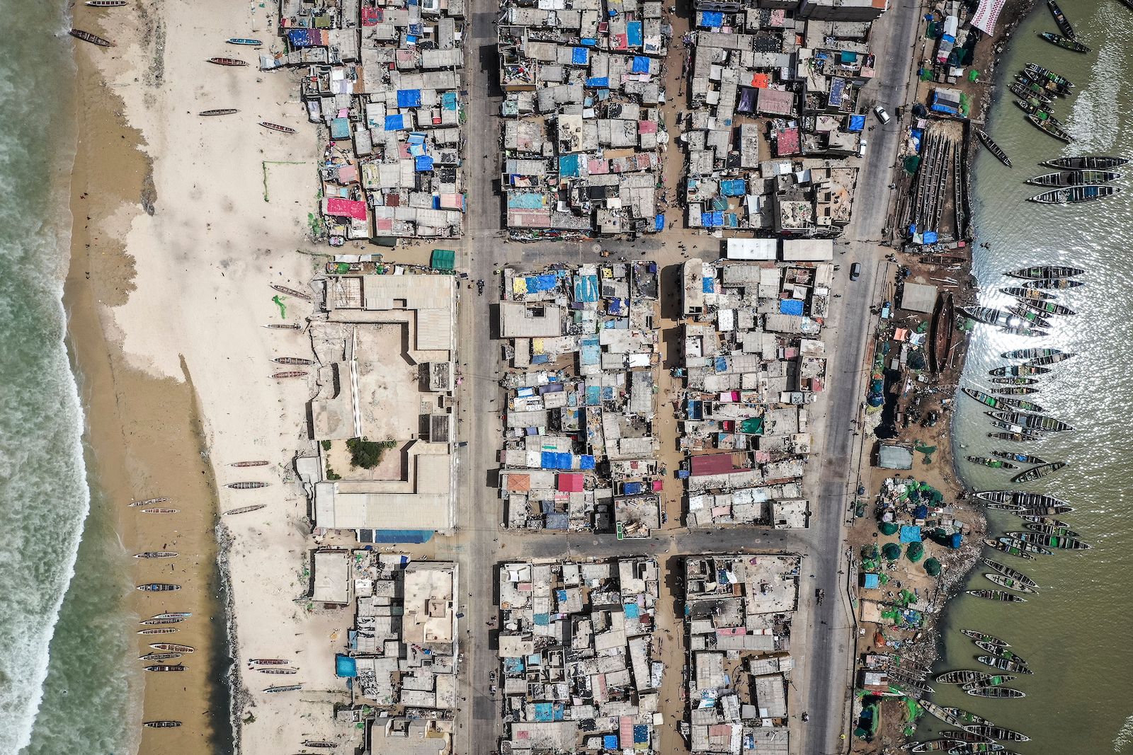 an aerial view of a dense town with water on either side