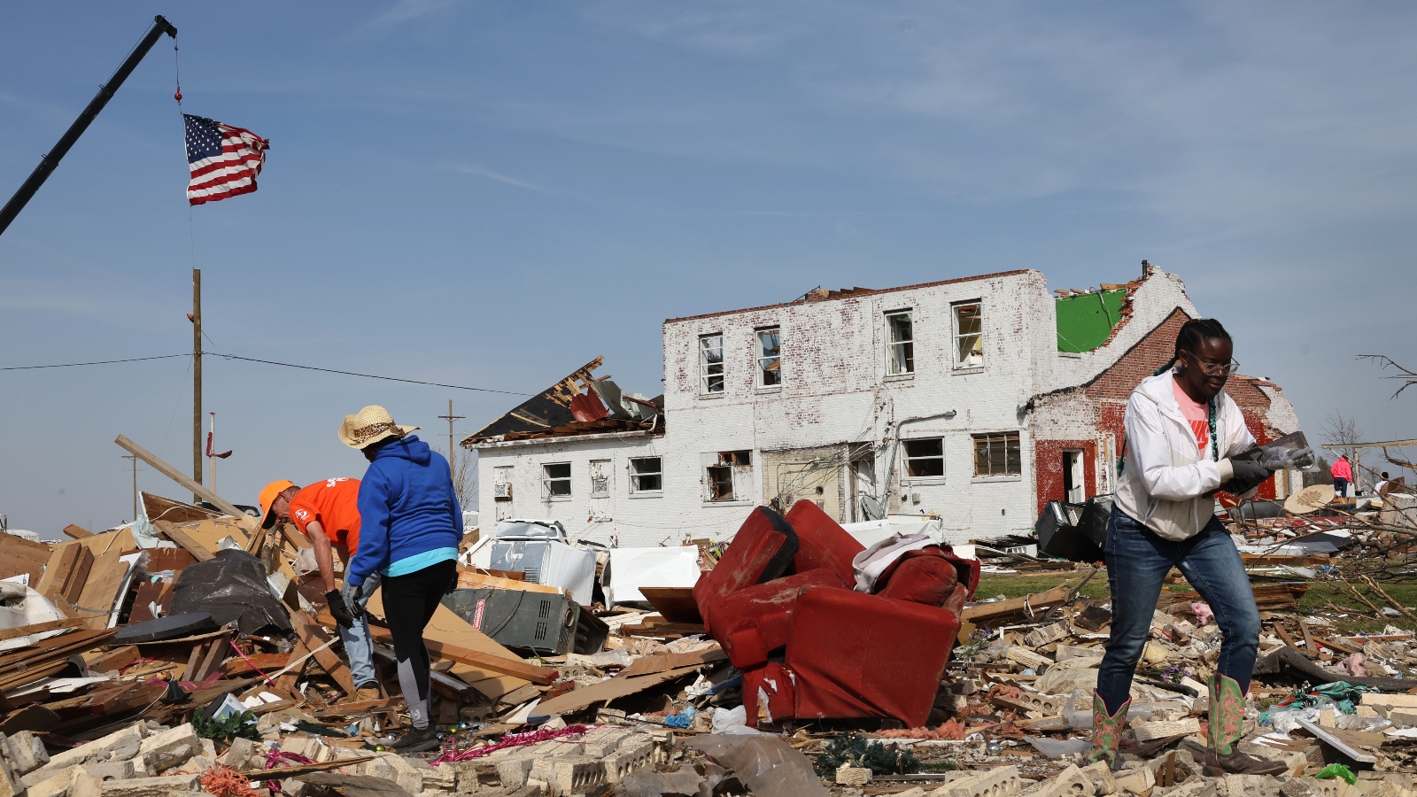 Residents and volunteers work to salvage possessions among the rubble of homes in the aftermath of a tornado that struck Rolling Fork, Mississippi on March 24, 2023.