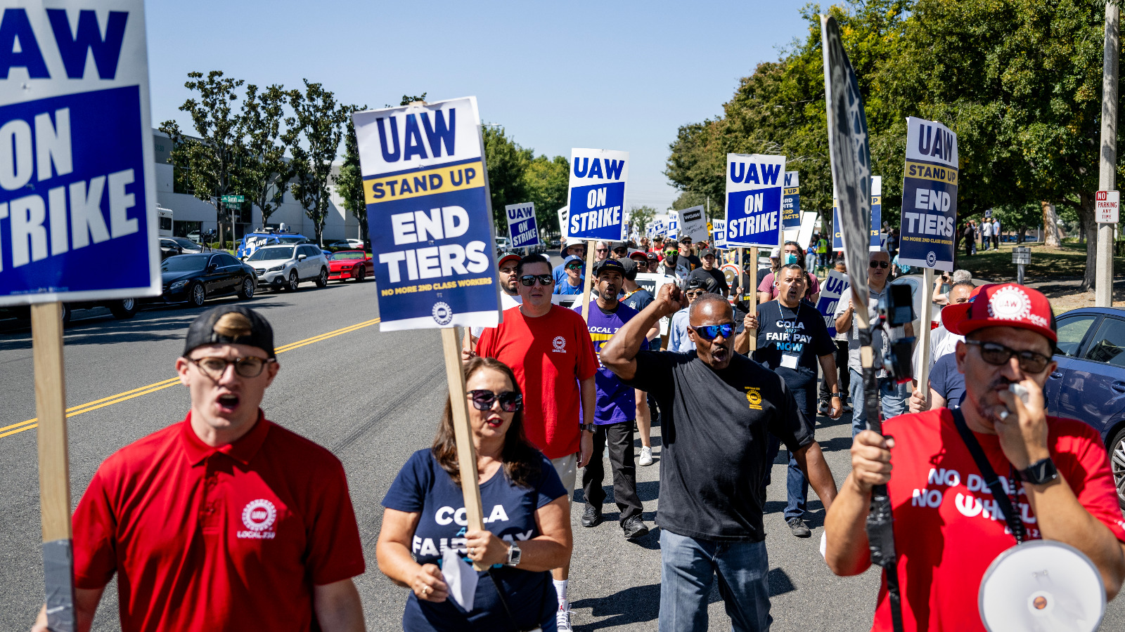 Photo of demonstrators on strike holding United Auto Workers signs