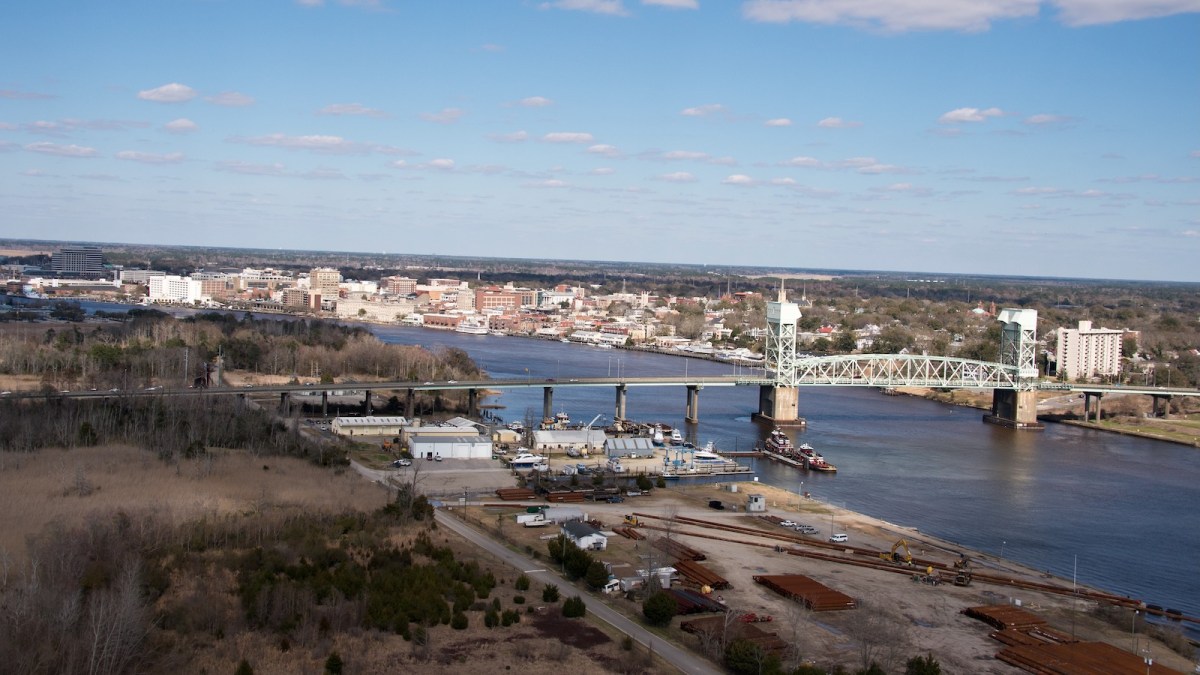 An aerial view of the Cape Fear Memorial Bridge spanning the Cape Fear River in Wilmington, North Carolina.