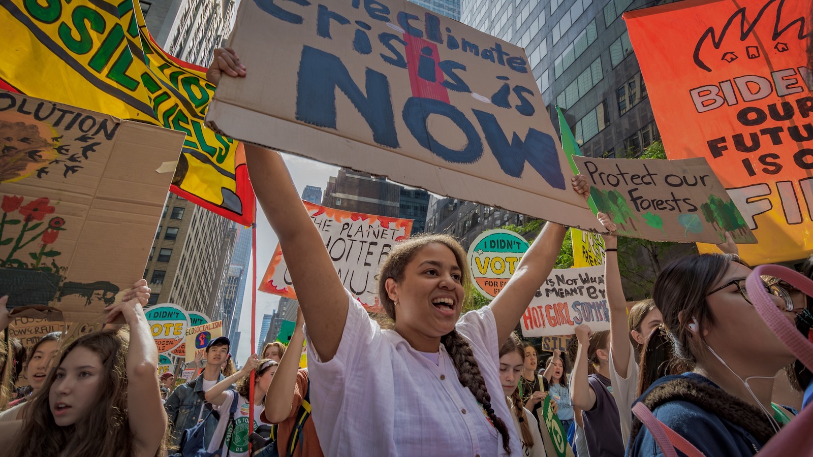 Youth climate activists waving pickets join a demonstration in New York City demanding climate action.