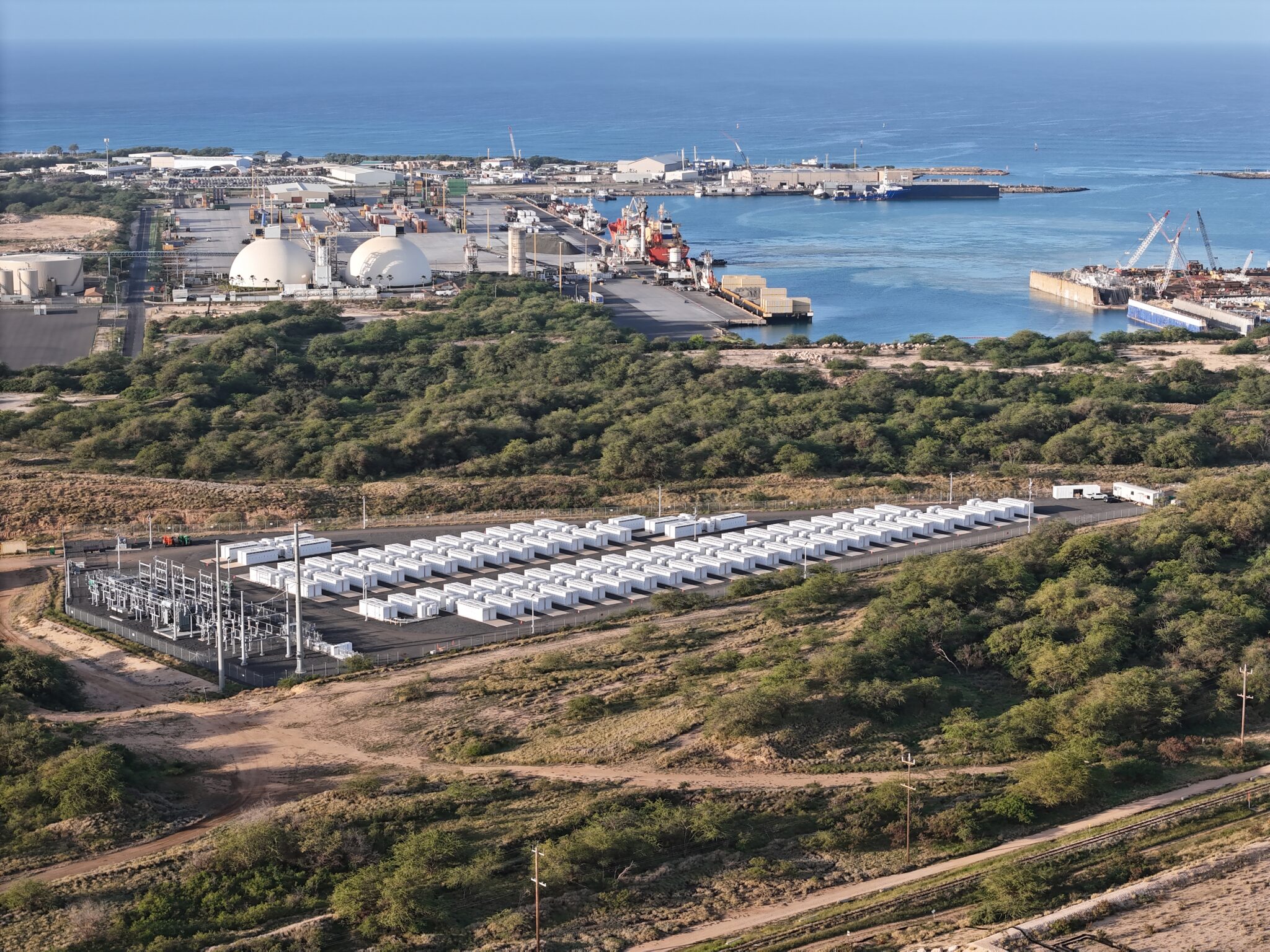 An overhead view of a battery farm next to the sea.