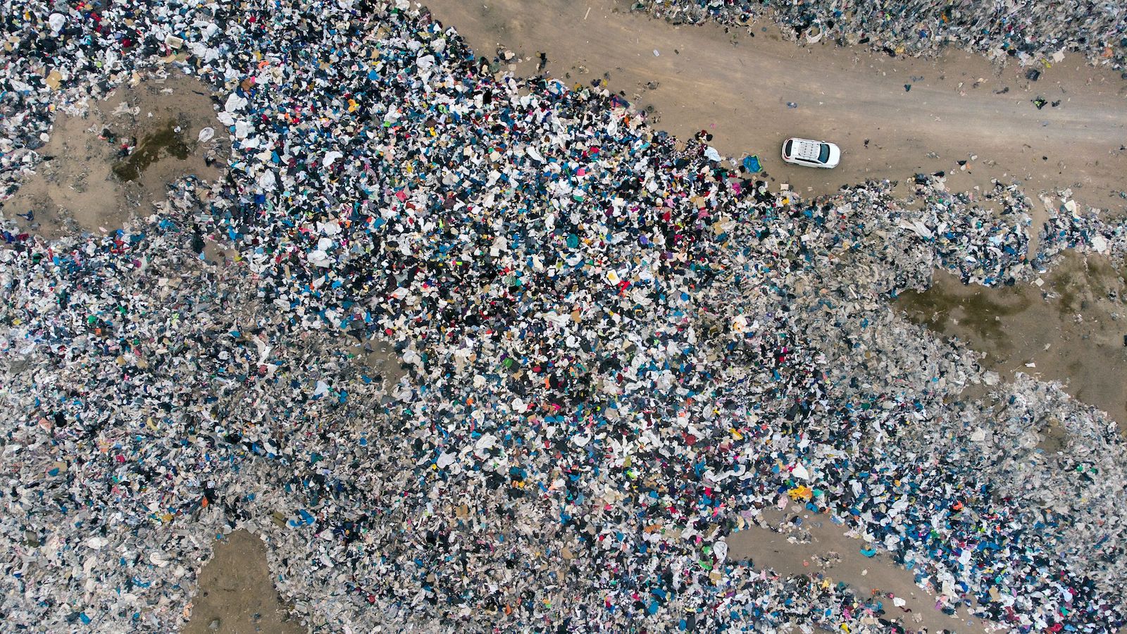 a huge pile of clothing in the desert as seen from a drone