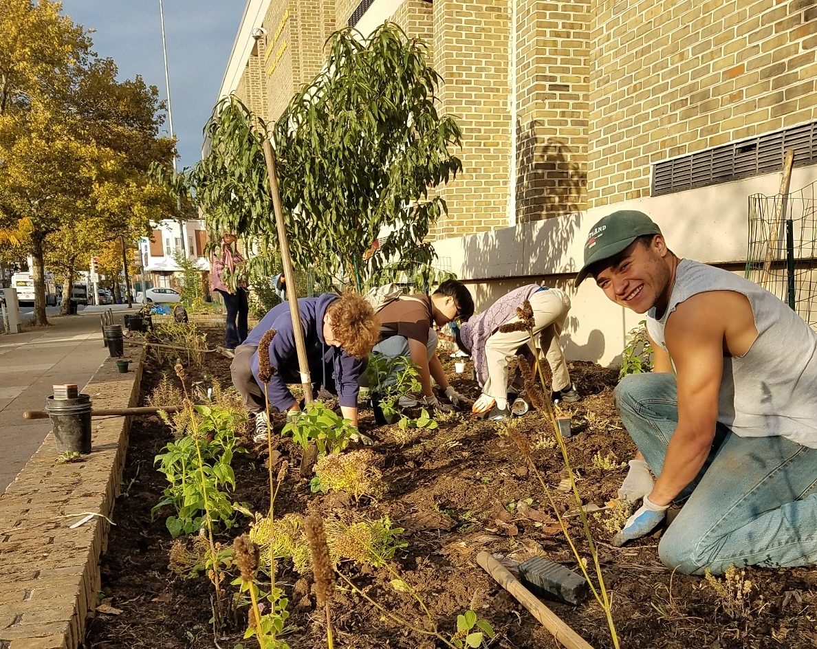Volunteers plant trees at an urban orchard in Philadelphia