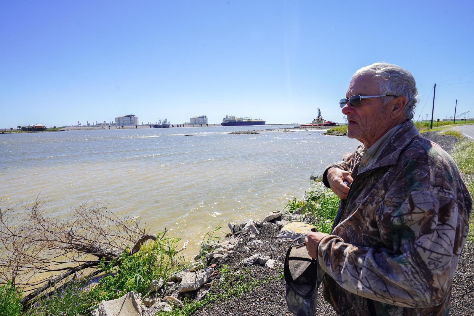 John Allaire, a retired fisherman, stands near Venture Global's LNG export terminal in Cameron, Louisiana. Allaire has been a vocal critic of the company's proposed CP2 facility.