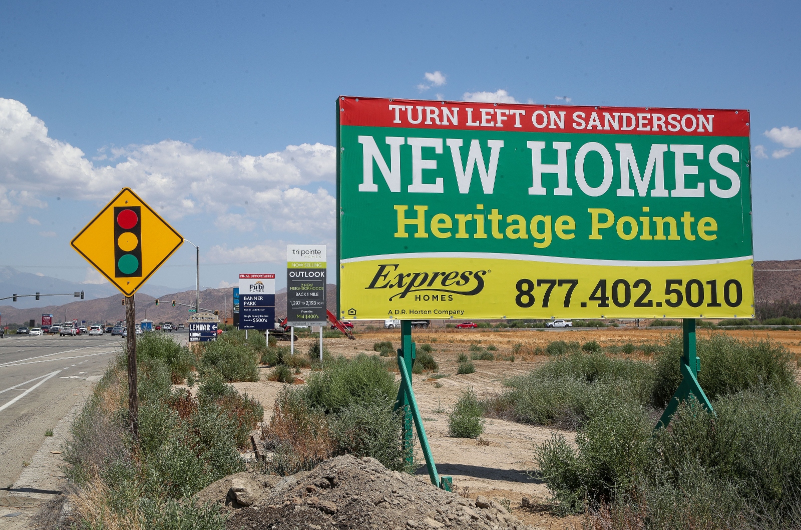 Signs advertising new homes are seen along Domenigoni Parkway in Winchester, California