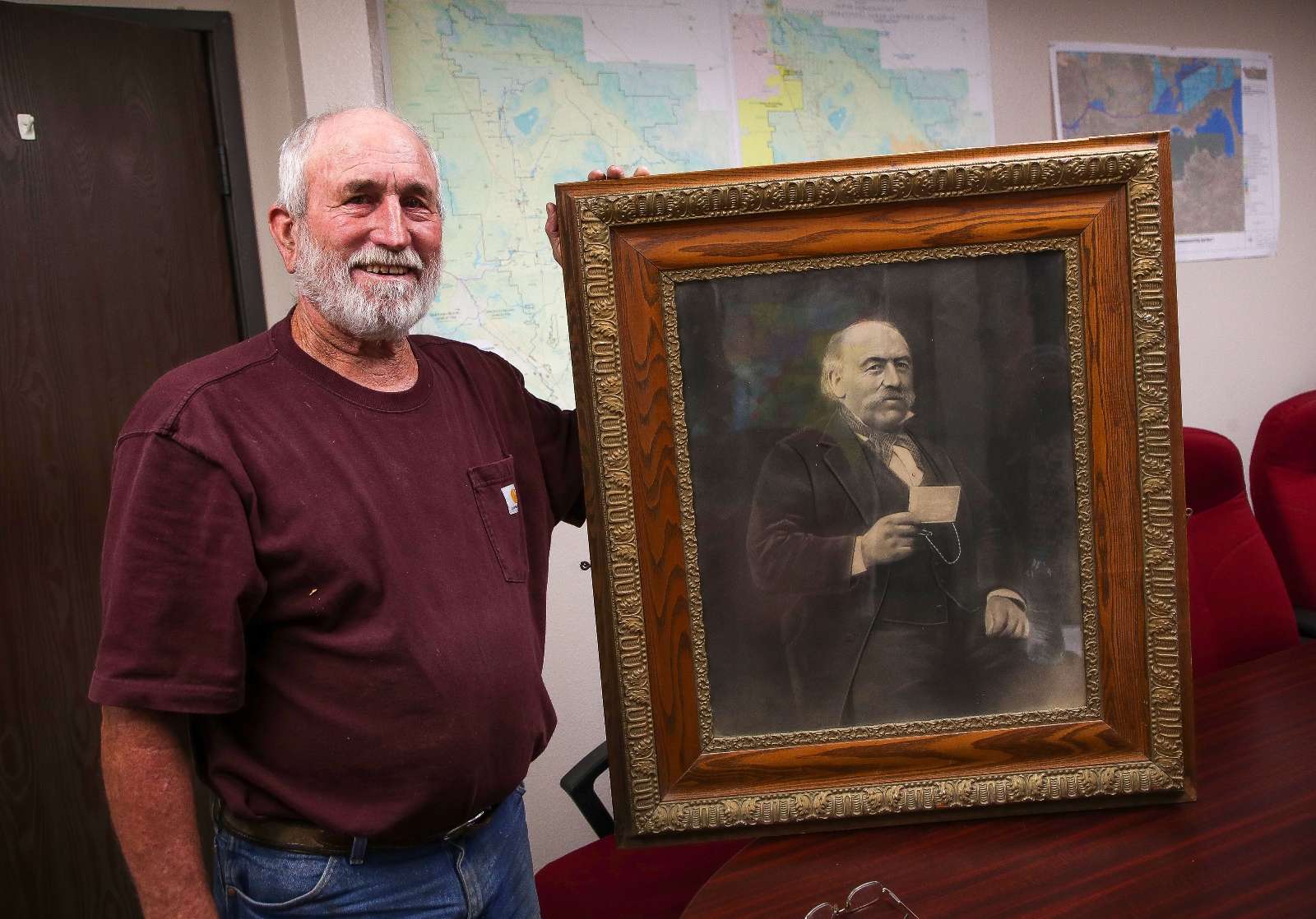 Andy Domenigoni holds a photo of his great-grandfather Angelo Domenigoni, who was one of the first settlers of Winchester, California.