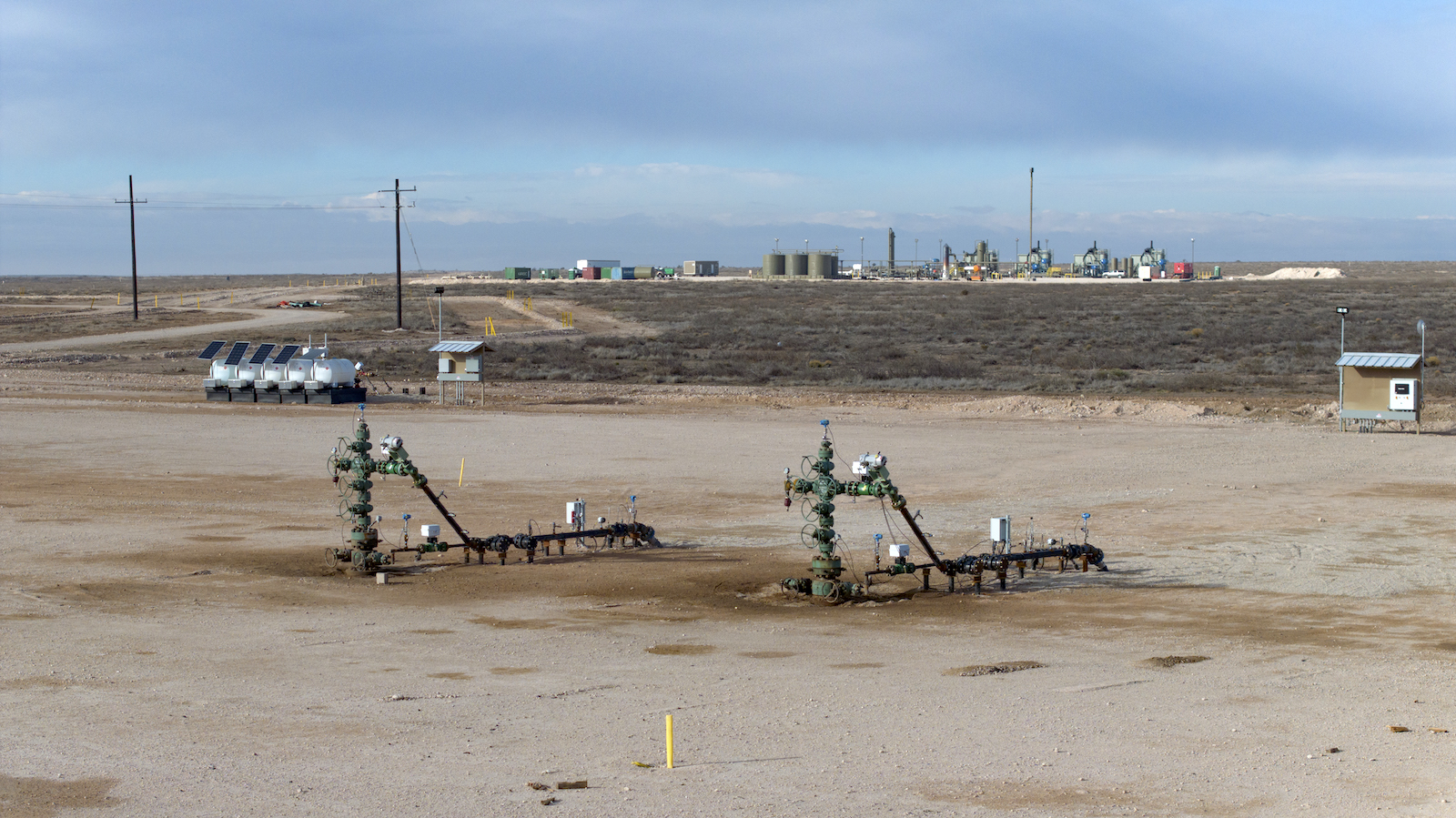 fracking pipes coming out of a dirt plot