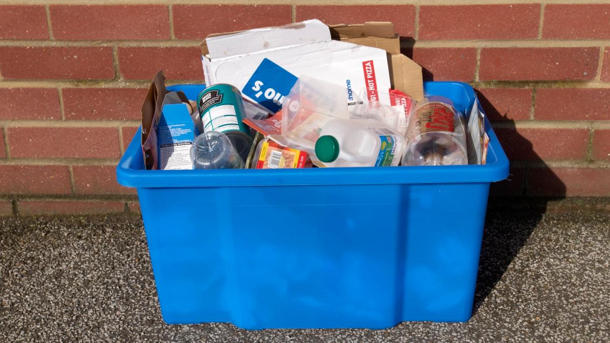 Blue box full of plastic and paper