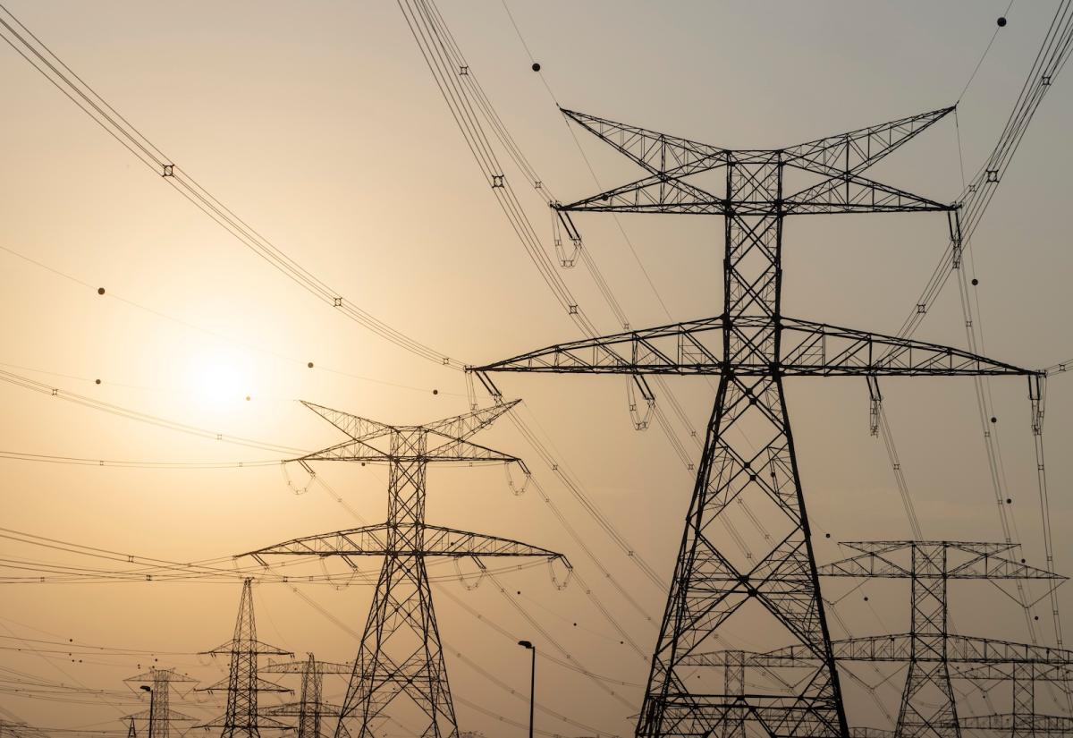 Power lines with sun in background