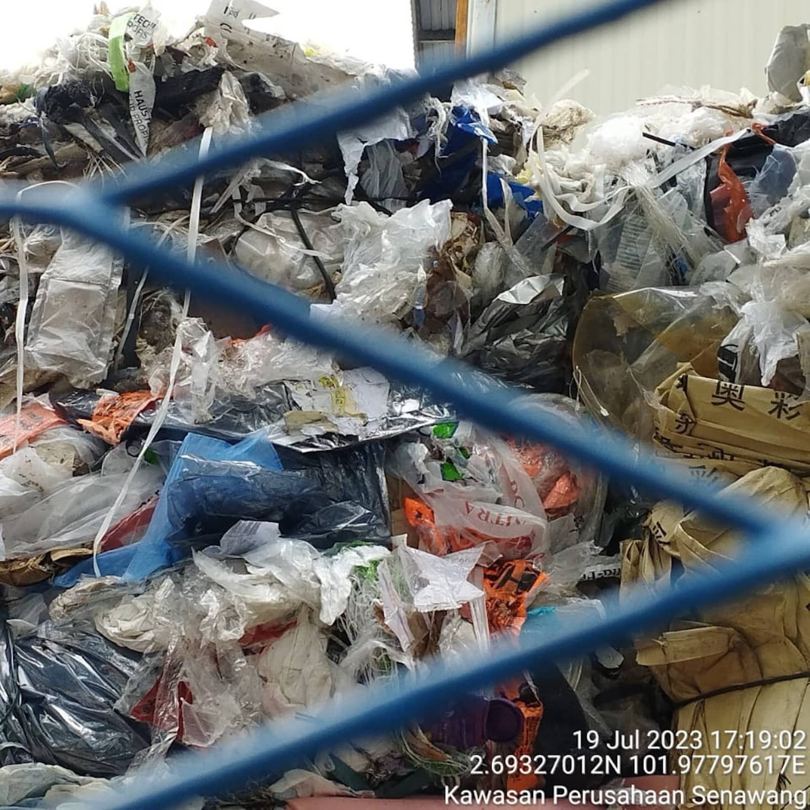 Dirty colored plastic bags piled outside at Jinma