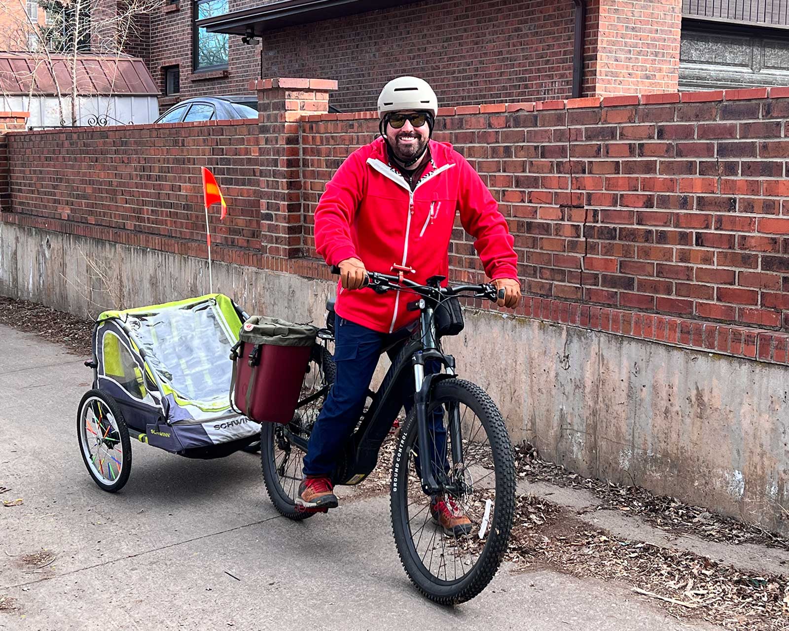 a man rides an e-bike with an attached trailer