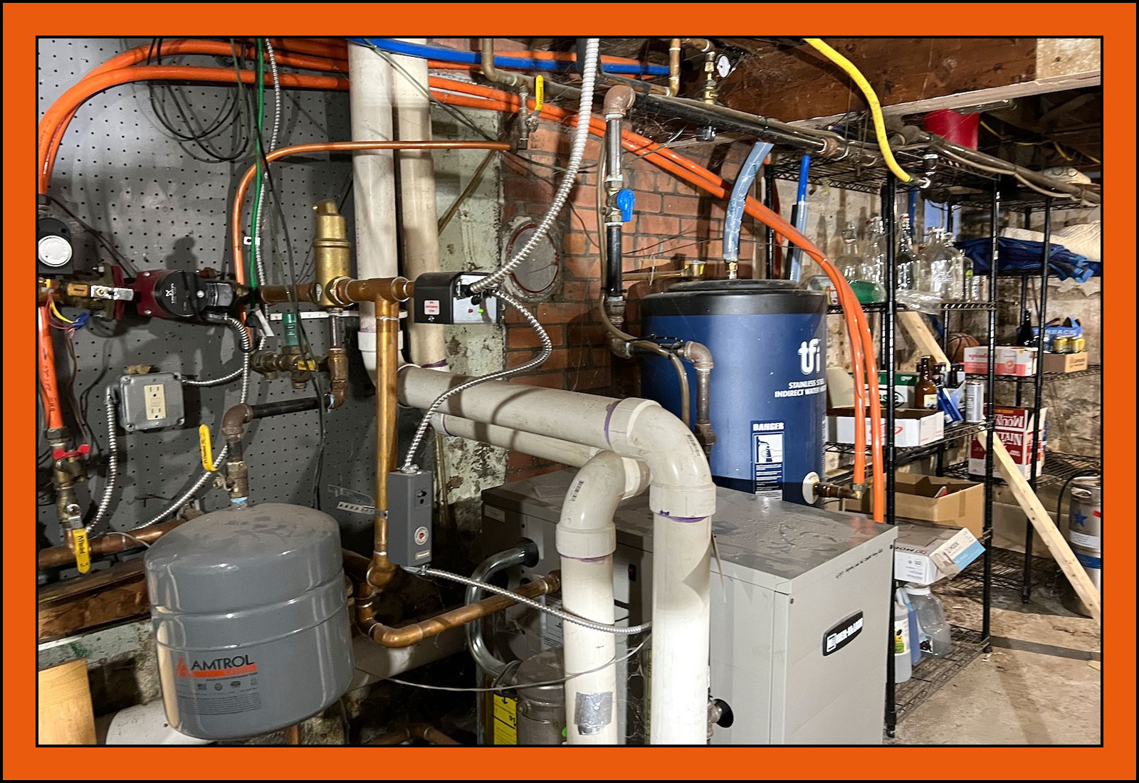 The gas boiler and old water heater in Tik's basement