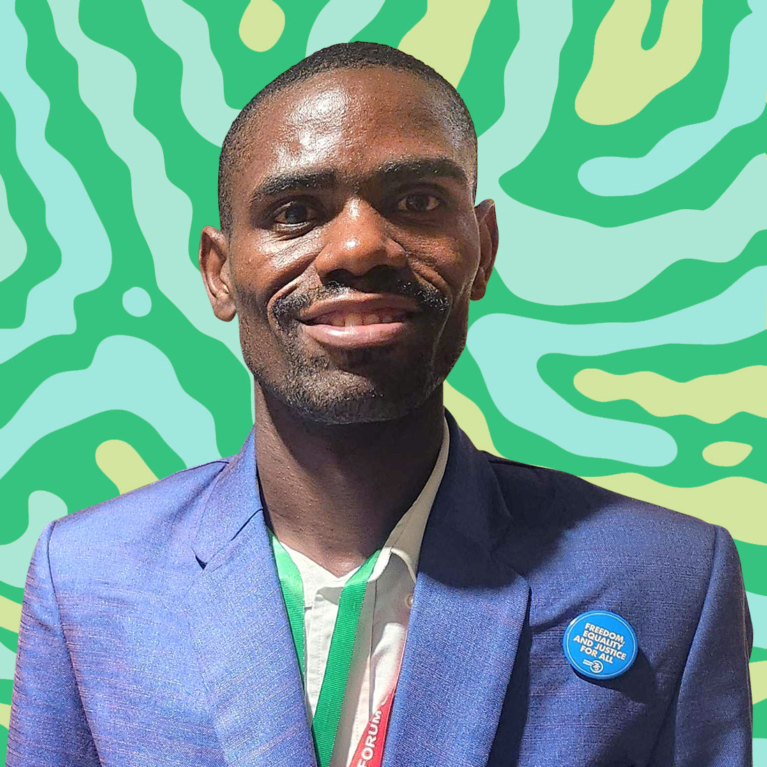 A headshot of a young person in a blue suit on a green and yellow striped background