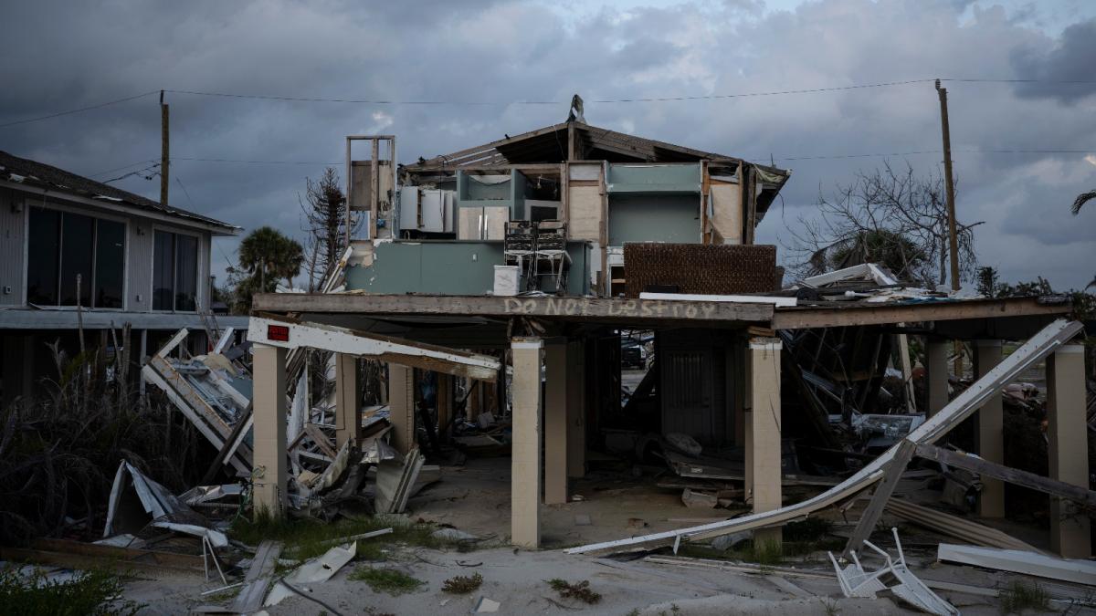 A damaged home stands in Fort Myers Beach, Florida, more than nine months after Hurricane Ian.