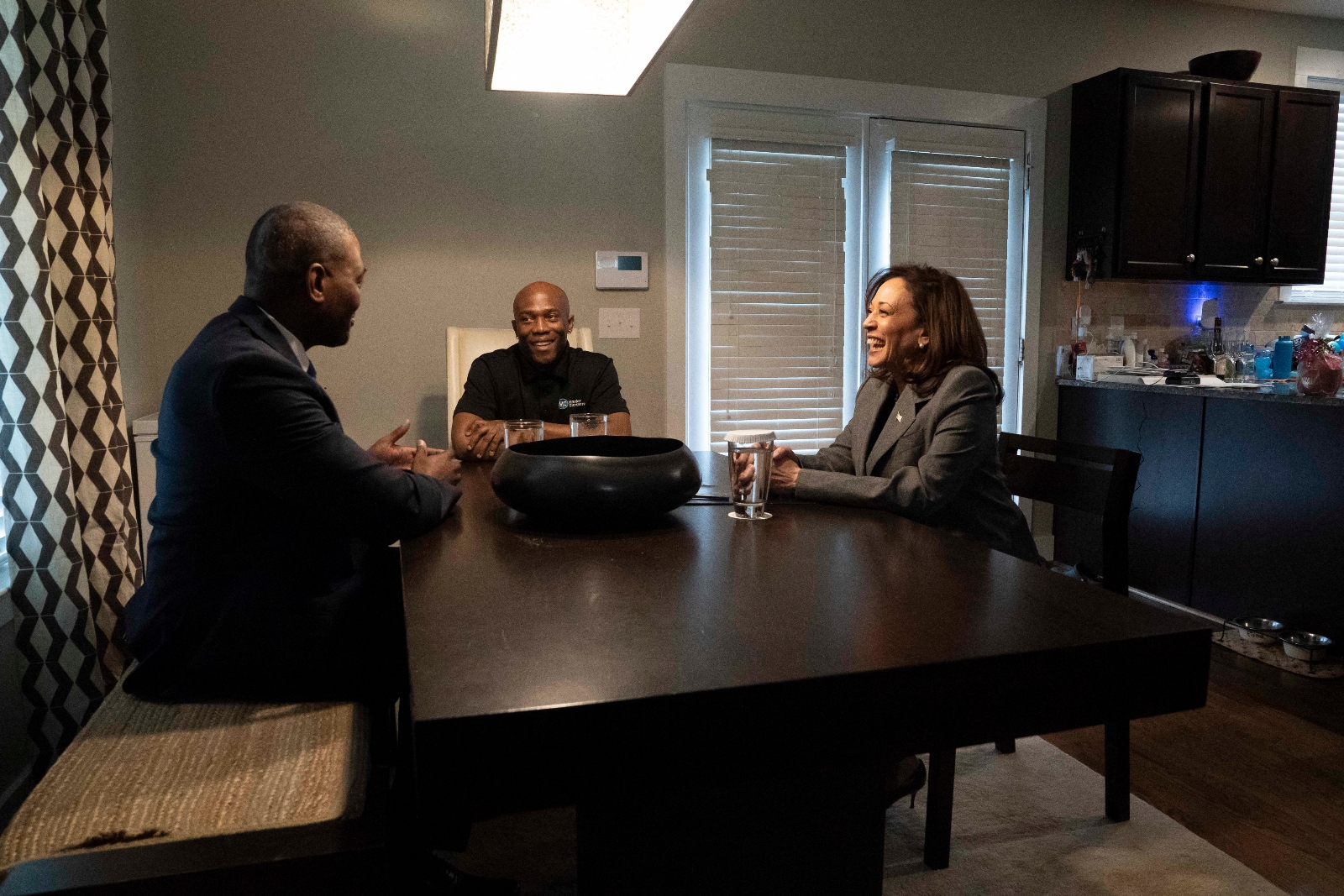 Vice President Kamala Harris, right, and EPA administrator Michael Regan, left, visit the home of Levon McBride in Charlotte, North Carolina, on April 4, 2024.