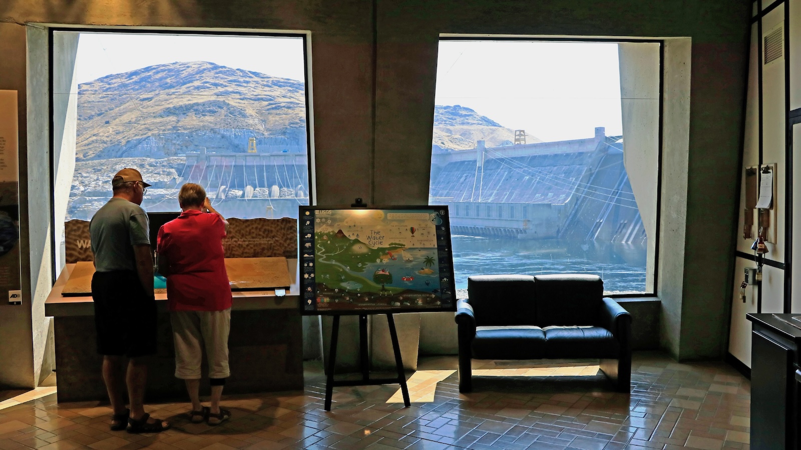 The Grand Coulee Dam is seen through the windows of the dam's visitor center.