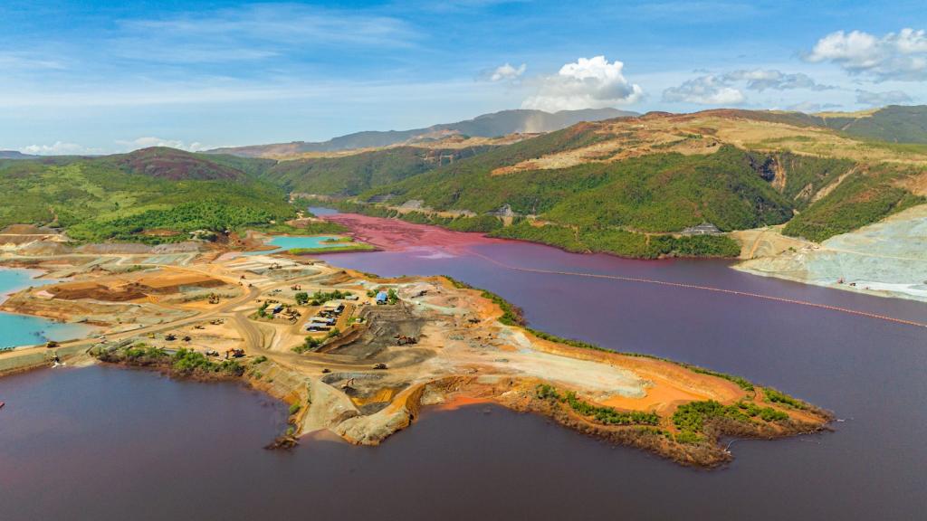 a colorful island with bright orange mining quarry