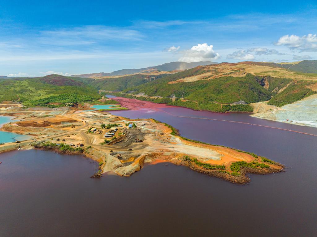 a colorful island with bright orange mining quarry
