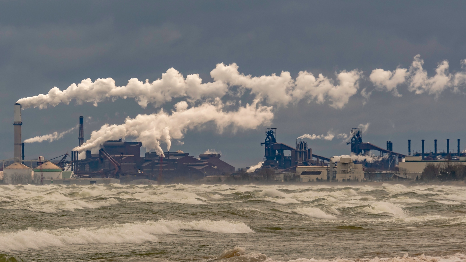 Steel mills along a lake on a stormy day