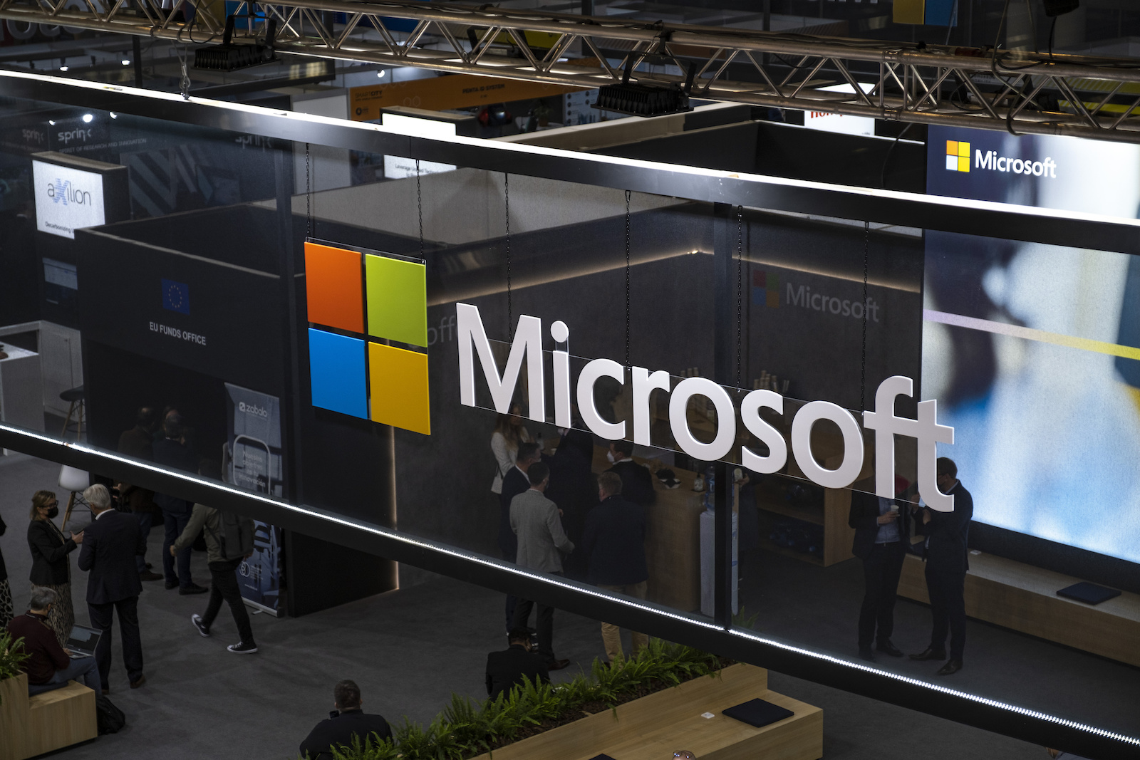 Microsoft logo over an expo with tech and people