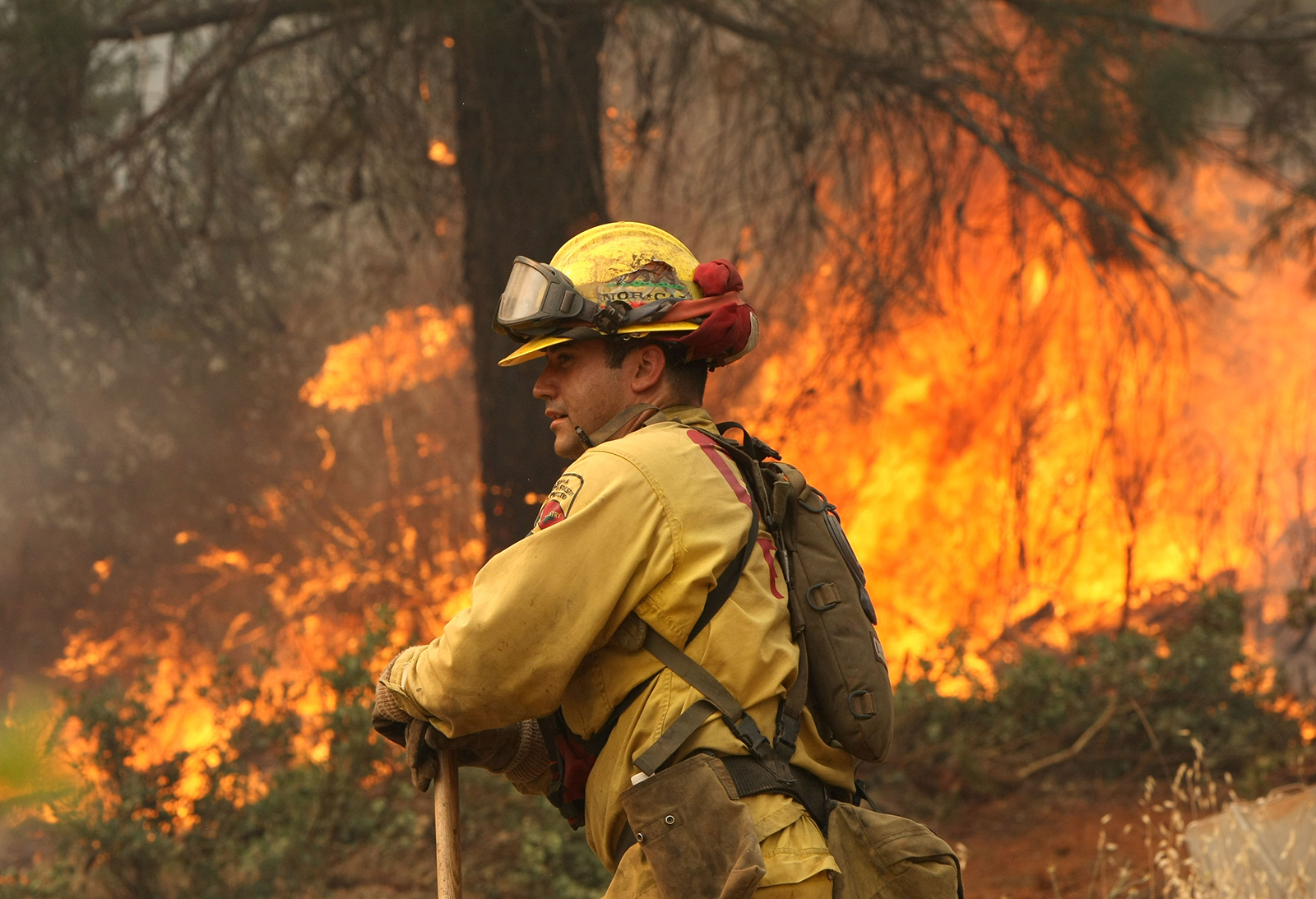 A wildland fire fighter near a blaze