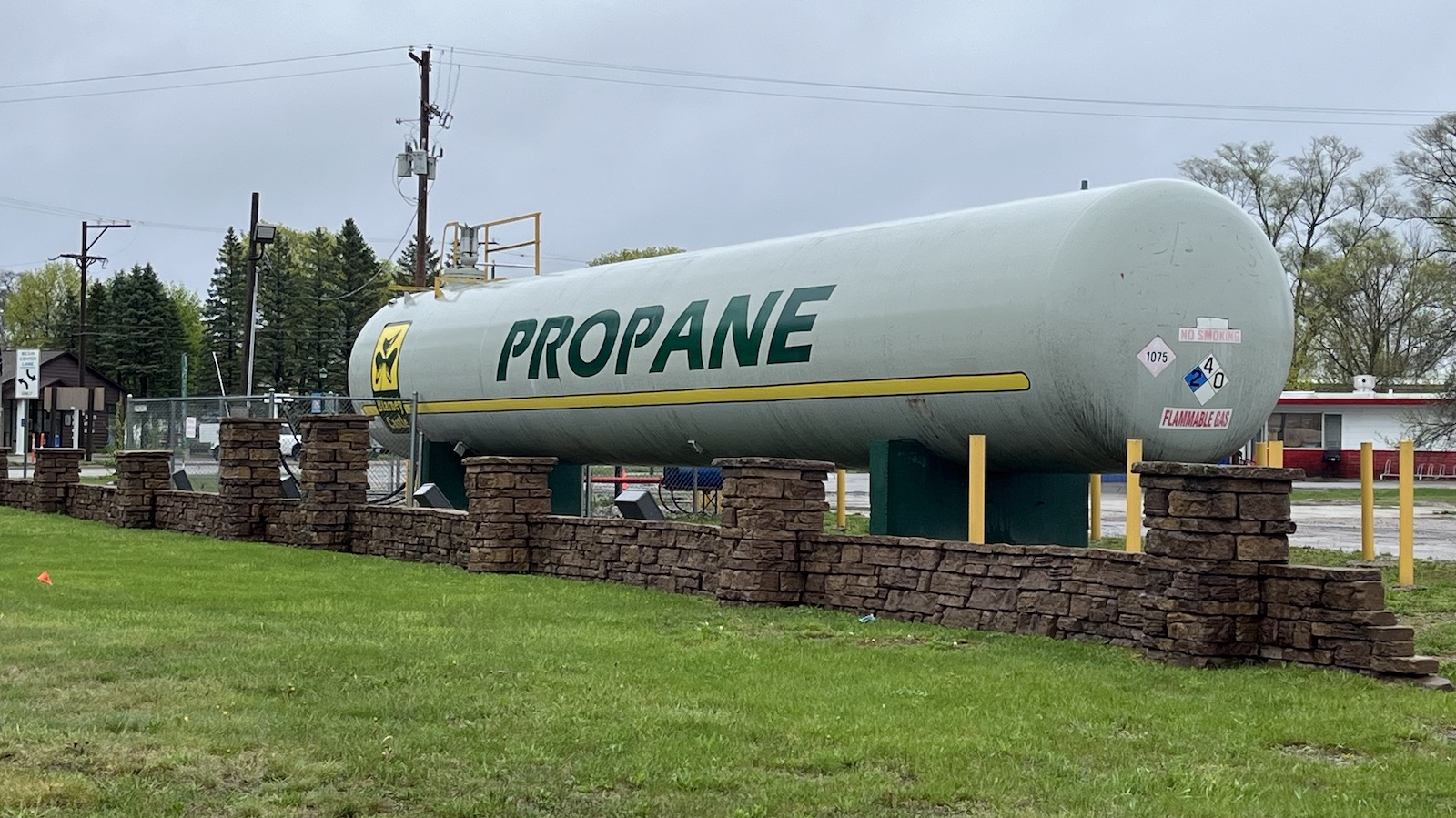 A large tubular tank with Propane painted on it in large letters.