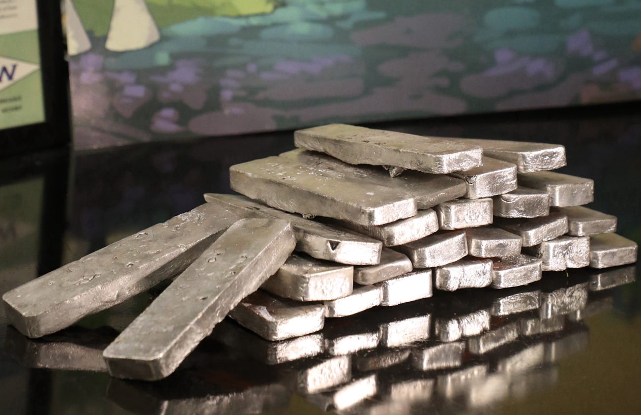 A pile of metal ingots on a table.