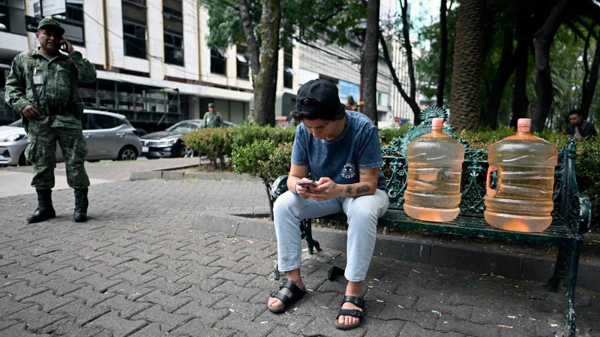 A resident of the borough of Benito Juarez in Mexico City rests after receiving drinking water. Many residents of the city have been affected by the contamination of groundwater wells amid a severe drought.