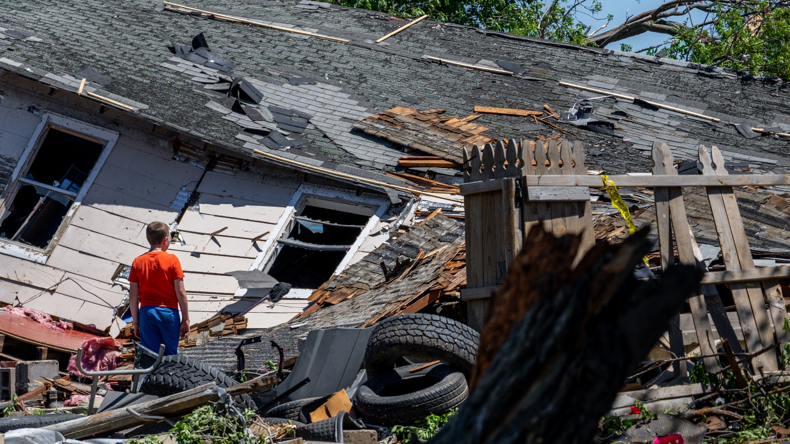 Zack Crowder views his home after it was struck by a tornado on May 7 in Barnsdall, Oklahoma. Oklahoma is one of several inland states that has seen skyrocketing insurance costs in recent years.