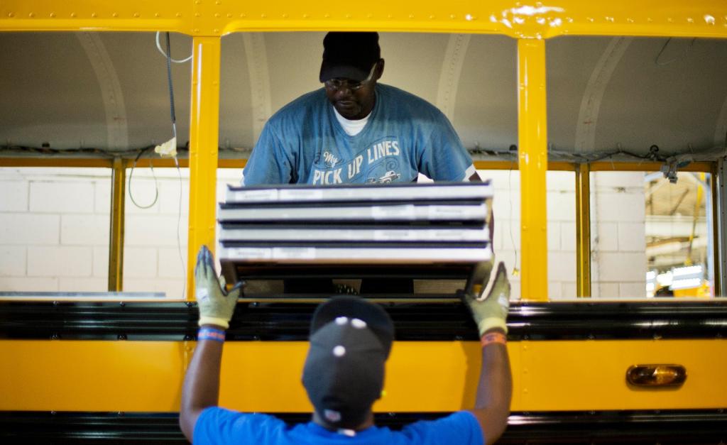 Employees work on a school bus on the assembly line at Blue Bird Corporation's manufacturing facility in Fort Valley, Ga.