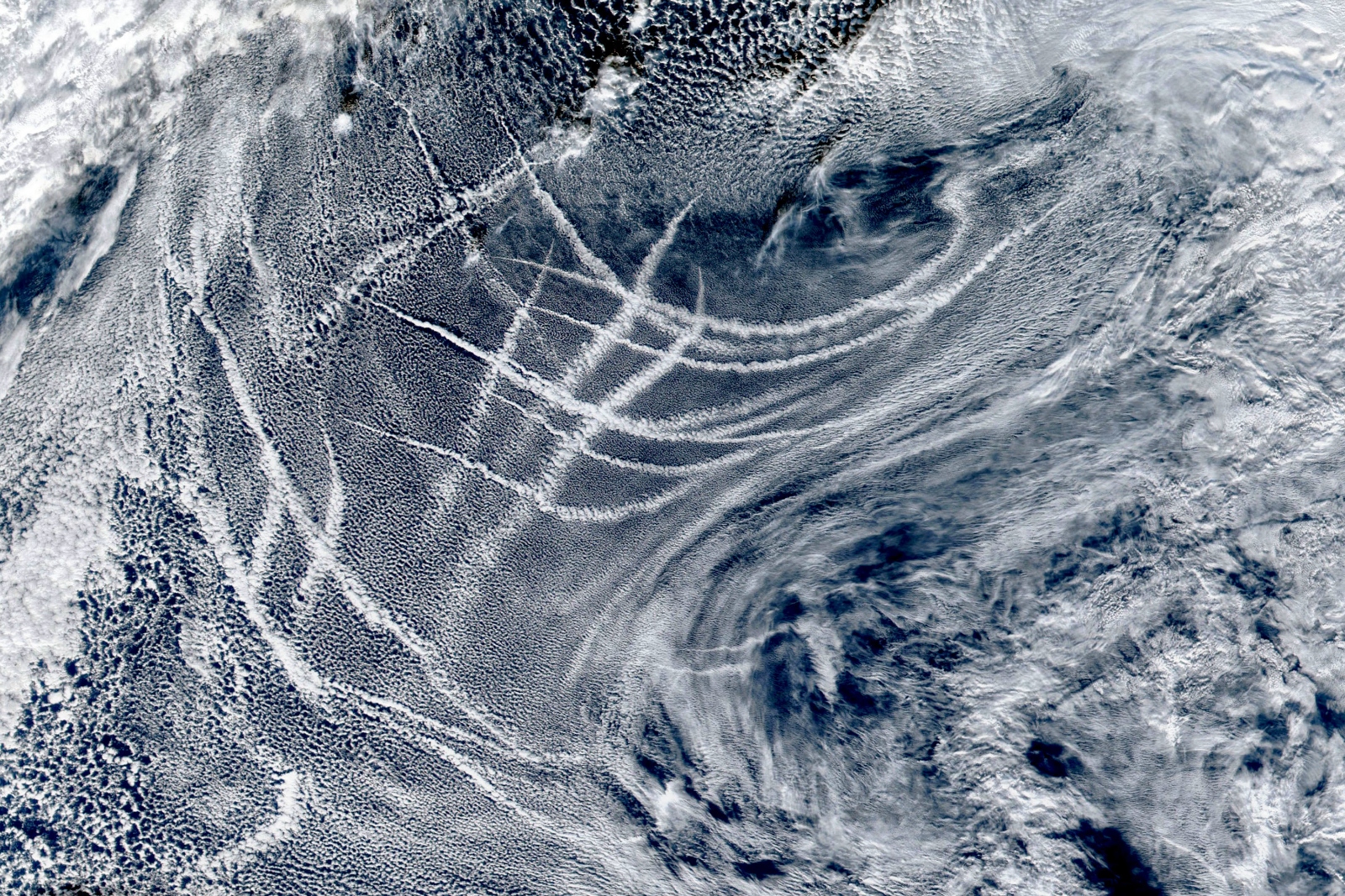 A satellite view of clouds and cloud trails.