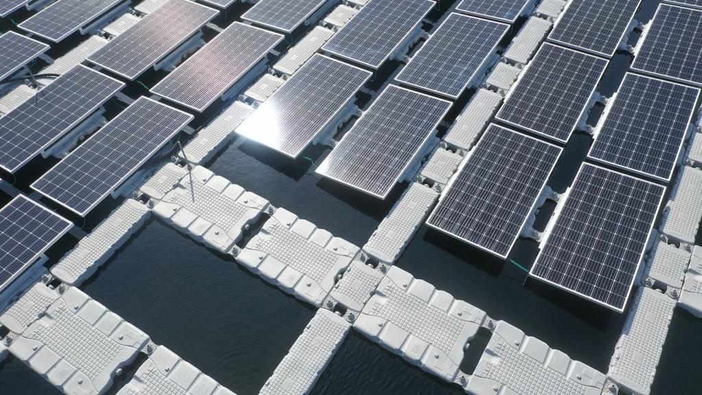 Aerial view of platforms on water with solar panels attached