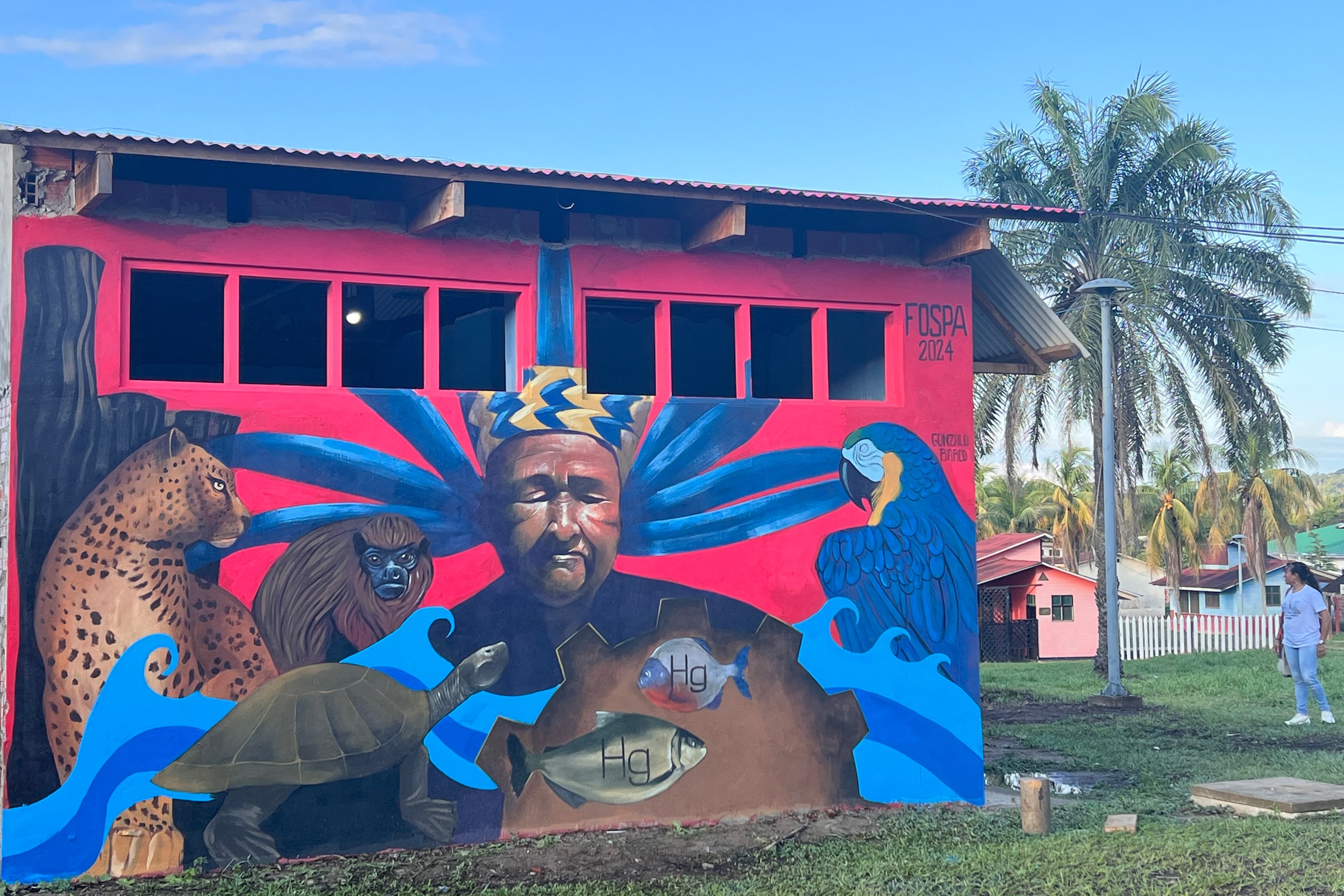 A colorful mural of an Indigenous person surrounded by Amazonian animals.