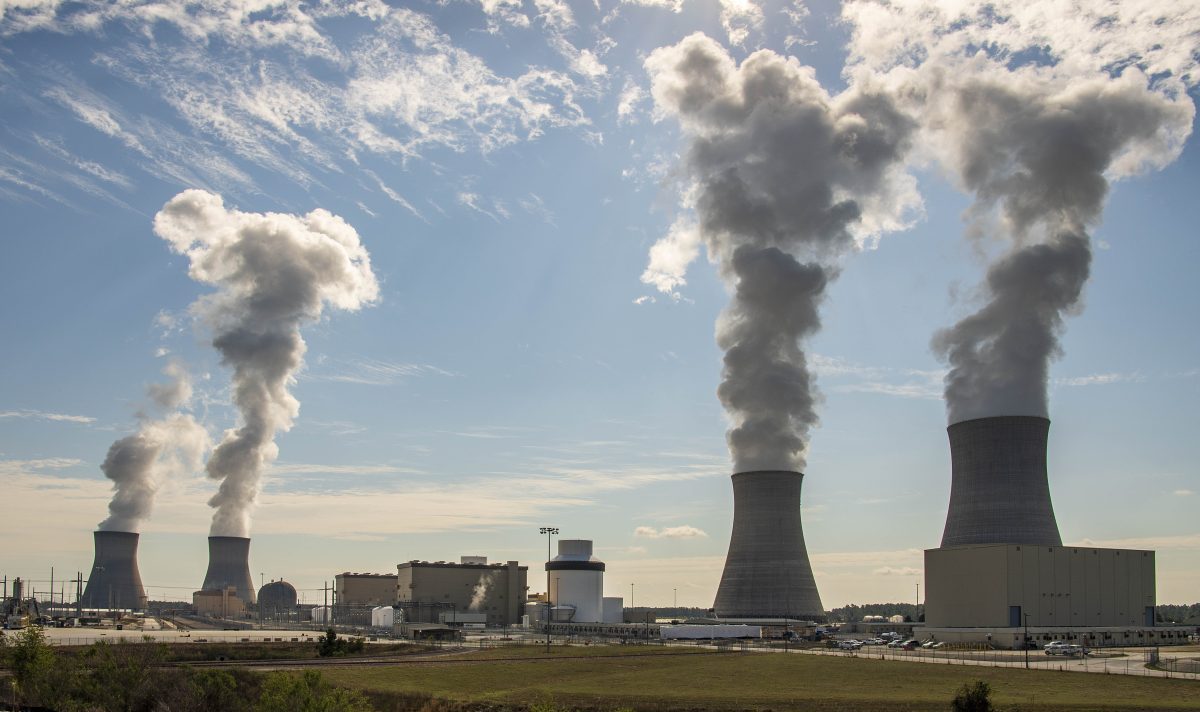 Four nuclear reactor units emitting steam.